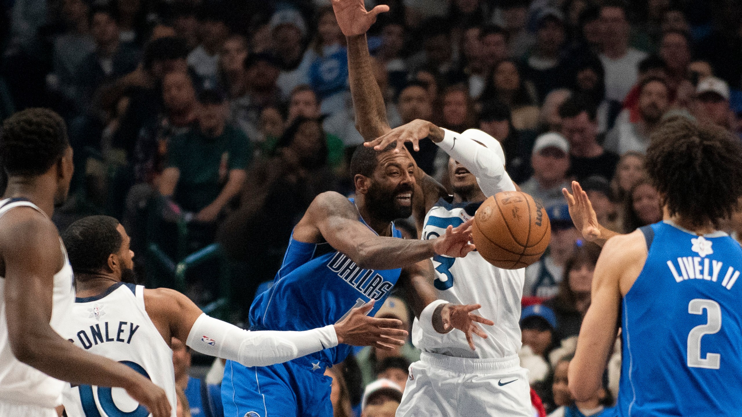 Dallas Mavericks guard Kyrie Irving (11) attempts to pass the ball to Dallas Mavericks center Dereck Lively II (2) in the first half of an NBA basketball game against the Minnesota Timberwolves on Wednesday, Dec. 25, 2024, in Dallas. (AP Photo/Emil T. Lippe)