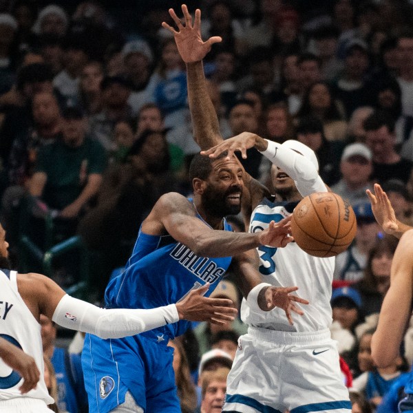 Dallas Mavericks guard Kyrie Irving (11) attempts to pass the ball to Dallas Mavericks center Dereck Lively II (2) in the first half of an NBA basketball game against the Minnesota Timberwolves on Wednesday, Dec. 25, 2024, in Dallas. (AP Photo/Emil T. Lippe)