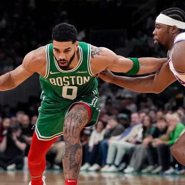 Boston Celtics' Jayson Tatum (0) drives past Philadelphia 76ers' Guerschon Yabusele during the first half of an NBA basketball game, Wednesday, Dec. 25, 2024, in Boston (AP Photo/Michael Dwyer)