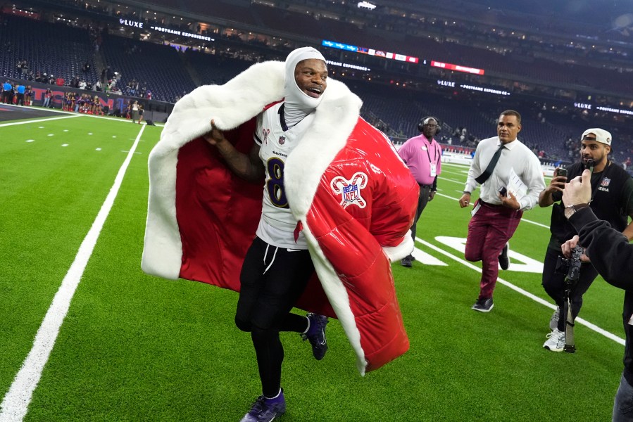 Baltimore Ravens quarterback Lamar Jackson (8) runs off the field after an NFL football game against the Houston Texans, Wednesday, Dec. 25, 2024, in Houston. (AP Photo/David J. Phillip)