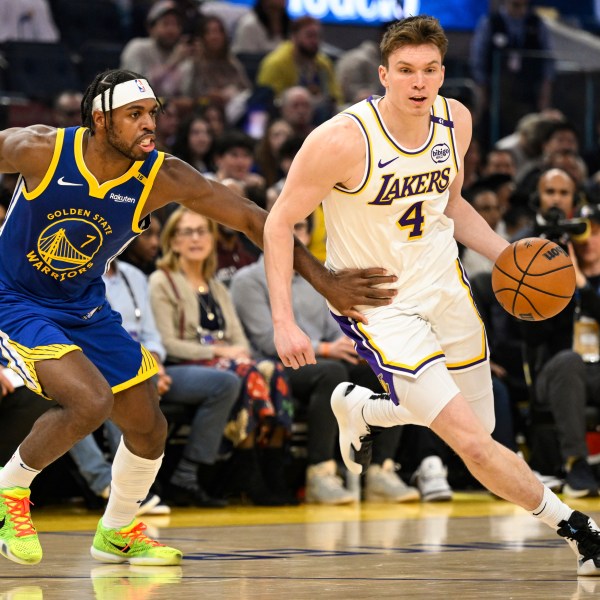 Los Angeles Lakers guard Dalton Knecht (4) dribbles against Golden State Warriors guard Buddy Hield (7) during the first half of an NBA basketball game, Wednesday, Dec. 25, 2024, in San Francisco. (AP Photo/Eakin Howard)