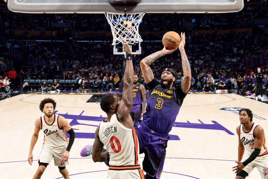 Los Angeles Lakers forward Anthony Davis (3) shoots over Detroit Pistons center Jalen Duren (0) during the second half of an NBA basketball game in Los Angeles, Monday, Dec. 23, 2024. (AP Photo/Eric Thayer)