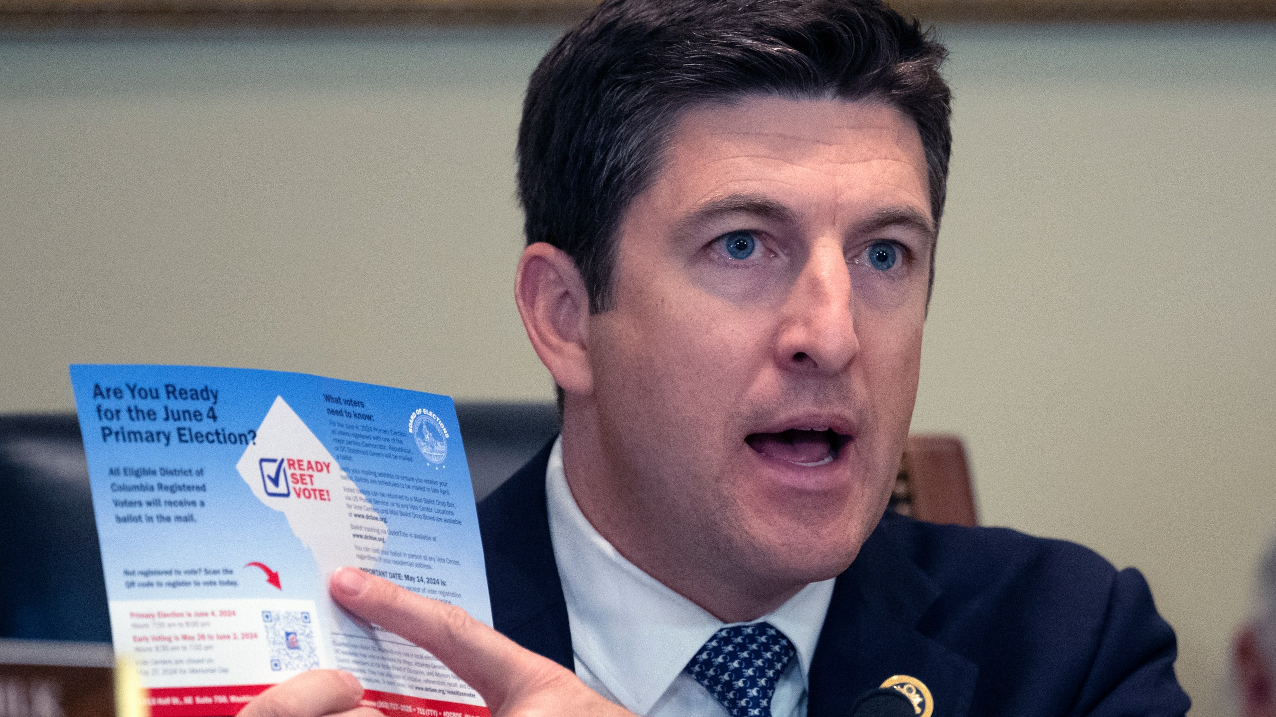 FILE - Bryan Steil, R-Wis., chairman of the Committee on House Administration, points to a election brochure for Washington, during a hearing he conducted about noncitizen voting on Capitol Hill, May 16, 2024 in Washington. (AP Photo/John McDonnell, File)