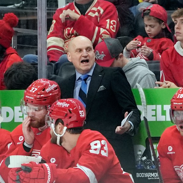 Detroit Red Wings head coach Derek Lalonde talks to his players during the second period of an NHL hockey game against the Montreal Canadiens, Friday, Dec. 20, 2024, in Detroit. (AP Photo/Carlos Osorio)