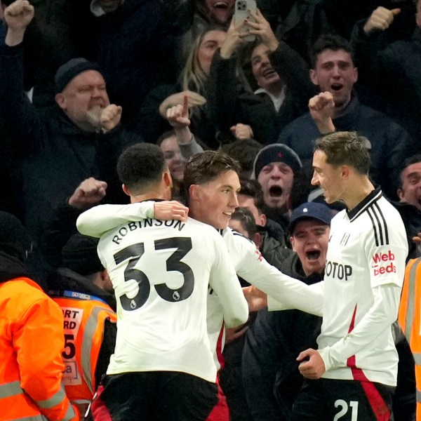 Fulham's Harry Wilson, center, celebrates after scoring his sides first goal during the English Premier League soccer match between Chelsea and Fulham at Stamford Bridge stadium in London, Thursday, Dec. 26, 2024. (AP Photo/Kirsty Wigglesworth)