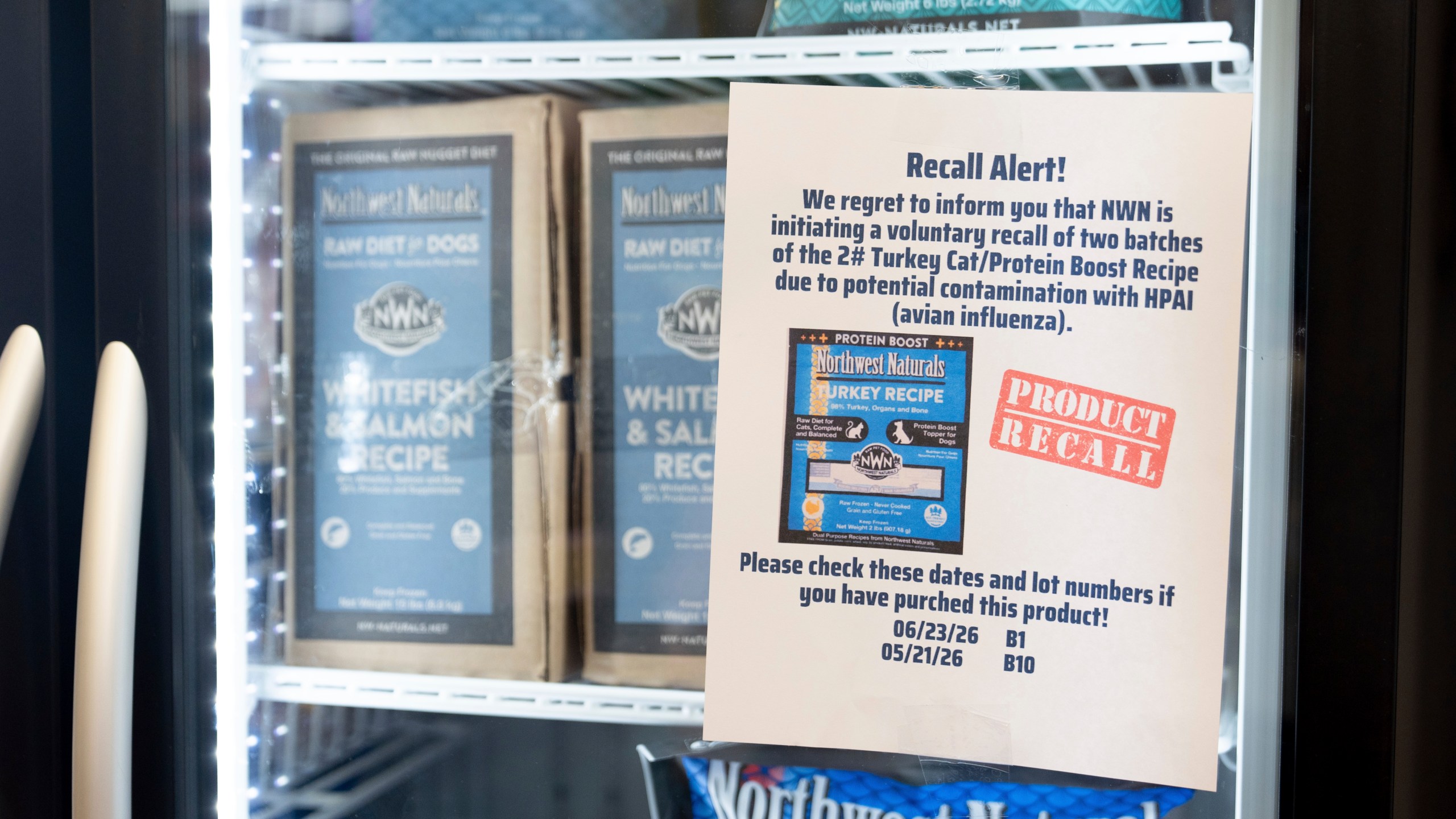 A recall alert is displayed on a refrigerator at a pet store in Tigard, Ore., on Thursday, Dec. 26, 2024, after Northwest Naturals announced a voluntary recall Tuesday of one batch of its 2-pound Feline Turkey Recipe raw frozen pet food after it tested positive for the virus. (AP Photo/Jenny Kane)