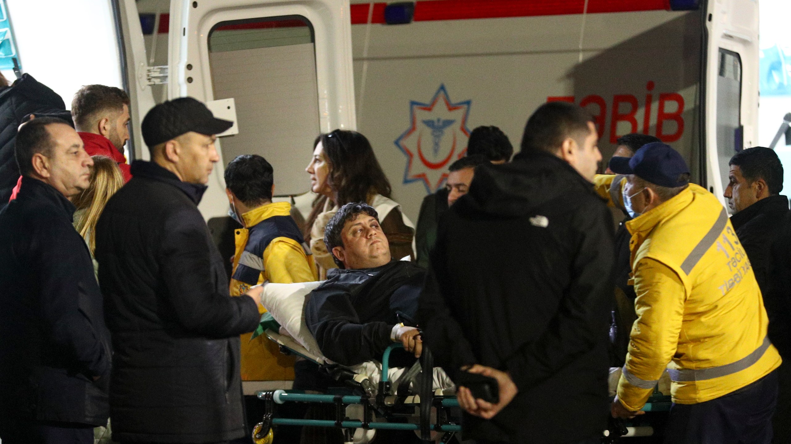 Rescuers transport wounded passengers from a medical plane after the Azerbaijani Airline crashed, near the Kazakhstani city of Aktau, upon their arrival at the Heydar Aliyev International Airport outside Baku, Azerbaijan, Thursday, Dec. 26, 2024. (AP Photo)