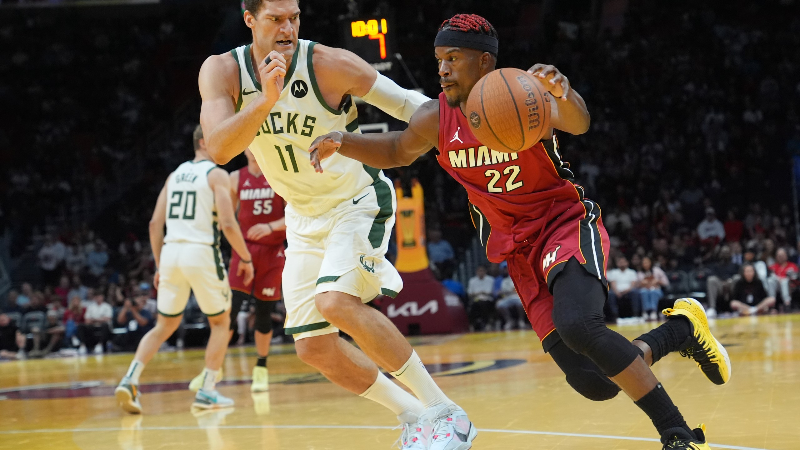 Miami Heat forward Jimmy Butler (22) drives to the basket as Milwaukee Bucks center Brook Lopez (11) defends during the second half of an Emirates NBA Cup basketball game, Tuesday, Nov. 26, 2024, in Miami. (AP Photo/Lynne Sladky)