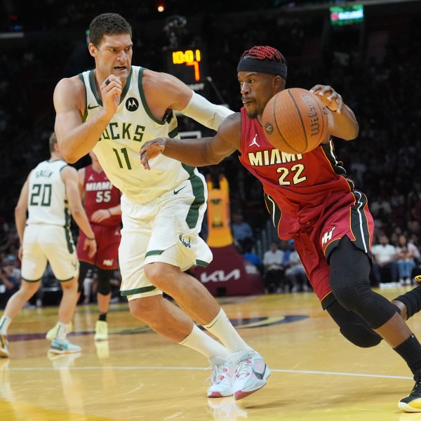 Miami Heat forward Jimmy Butler (22) drives to the basket as Milwaukee Bucks center Brook Lopez (11) defends during the second half of an Emirates NBA Cup basketball game, Tuesday, Nov. 26, 2024, in Miami. (AP Photo/Lynne Sladky)