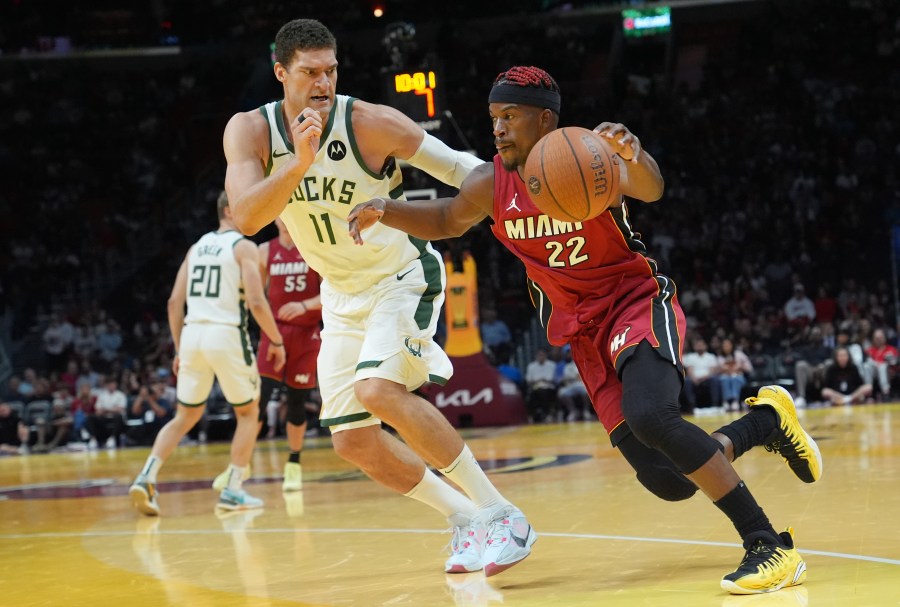 Miami Heat forward Jimmy Butler (22) drives to the basket as Milwaukee Bucks center Brook Lopez (11) defends during the second half of an Emirates NBA Cup basketball game, Tuesday, Nov. 26, 2024, in Miami. (AP Photo/Lynne Sladky)