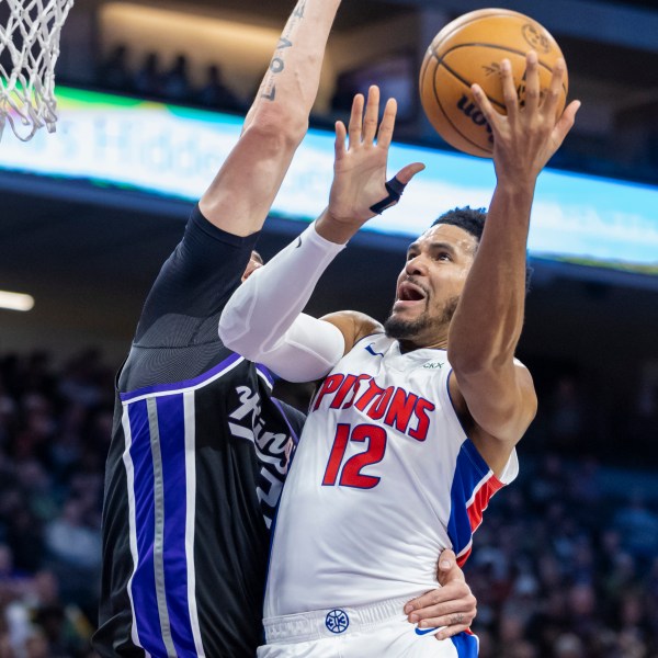 Detroit Pistons forward Tobias Harris (12) attempts a layup over Sacramento Kings center Alex Len, left, during the first half of an NBA basketball game Thursday, Dec. 26, 2024, in Sacramento, Calif. (AP Photo/Sara Nevis)