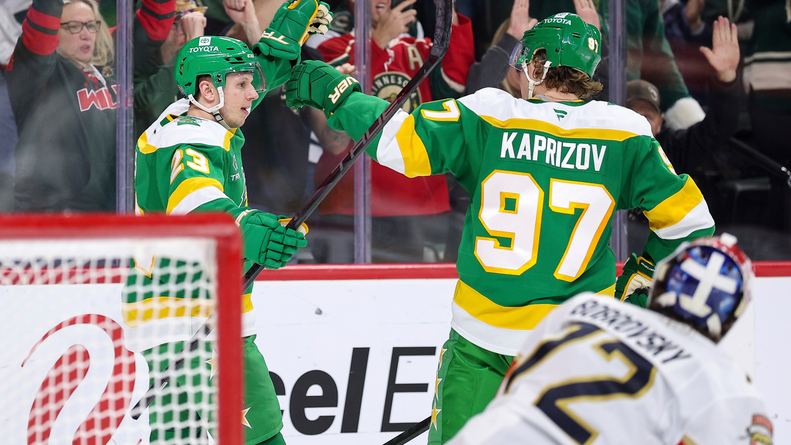 Minnesota Wild center Marco Rossi, left, celebrates his power-play goal with left wing Kirill Kaprizov (97) during the first period of an NHL hockey game against the Florida Panthers Wednesday, Dec. 18, 2024, in St. Paul, Minn. (AP Photo/Matt Krohn)