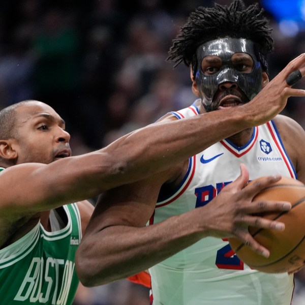 Philadelphia 76ers' Joel Embiid drives past Boston Celtics' Al Horford during the second half of an NBA basketball game, Wednesday, Dec. 25, 2024, in Boston (AP Photo/Michael Dwyer)