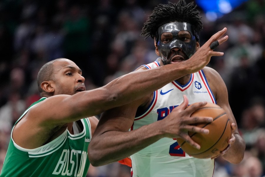 Philadelphia 76ers' Joel Embiid drives past Boston Celtics' Al Horford during the second half of an NBA basketball game, Wednesday, Dec. 25, 2024, in Boston (AP Photo/Michael Dwyer)