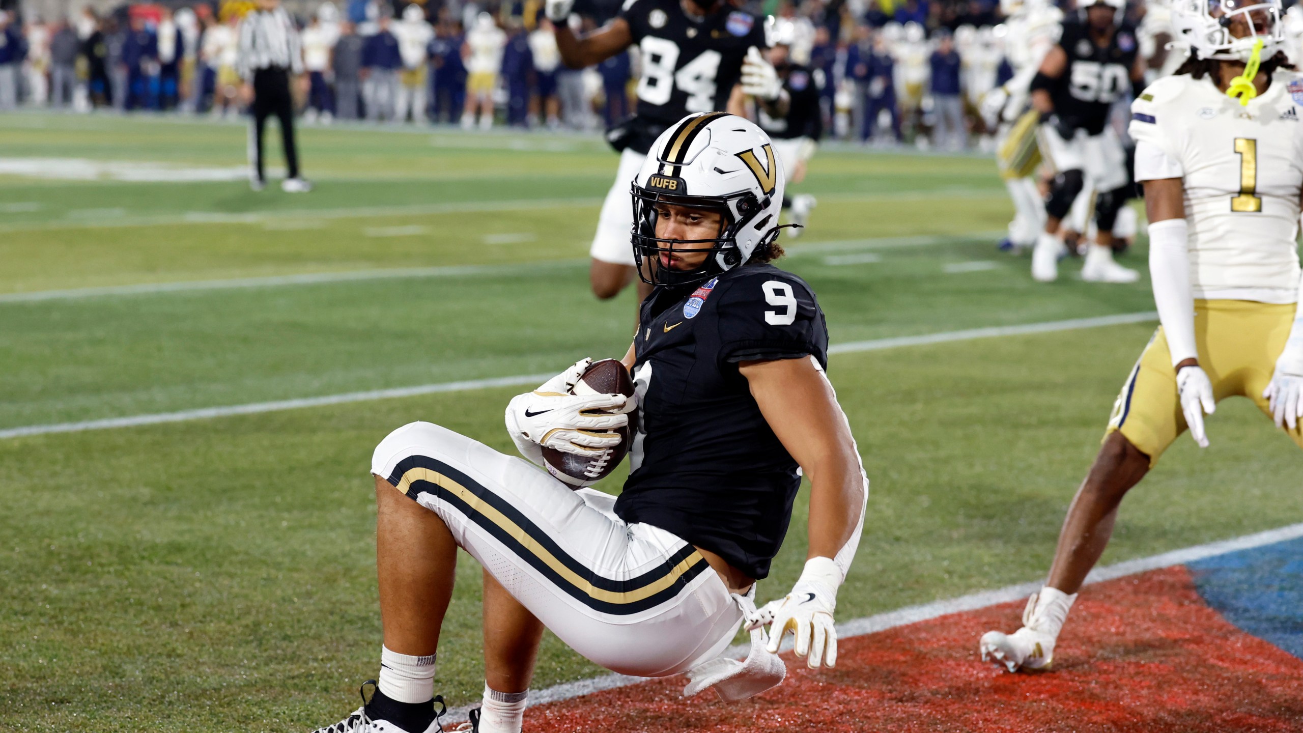 Vanderbilt tight end Eli Stowers (9) catches a pass for a touchdown against Georgia Tech during the second half of the Birmingham Bowl NCAA college football game, Friday, Dec. 27, 2024, in Birmingham, Ala. (AP Photo/Butch Dill)