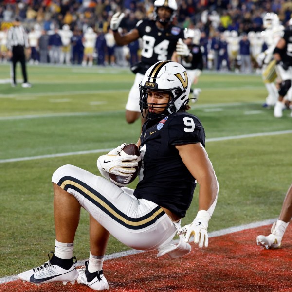 Vanderbilt tight end Eli Stowers (9) catches a pass for a touchdown against Georgia Tech during the second half of the Birmingham Bowl NCAA college football game, Friday, Dec. 27, 2024, in Birmingham, Ala. (AP Photo/Butch Dill)