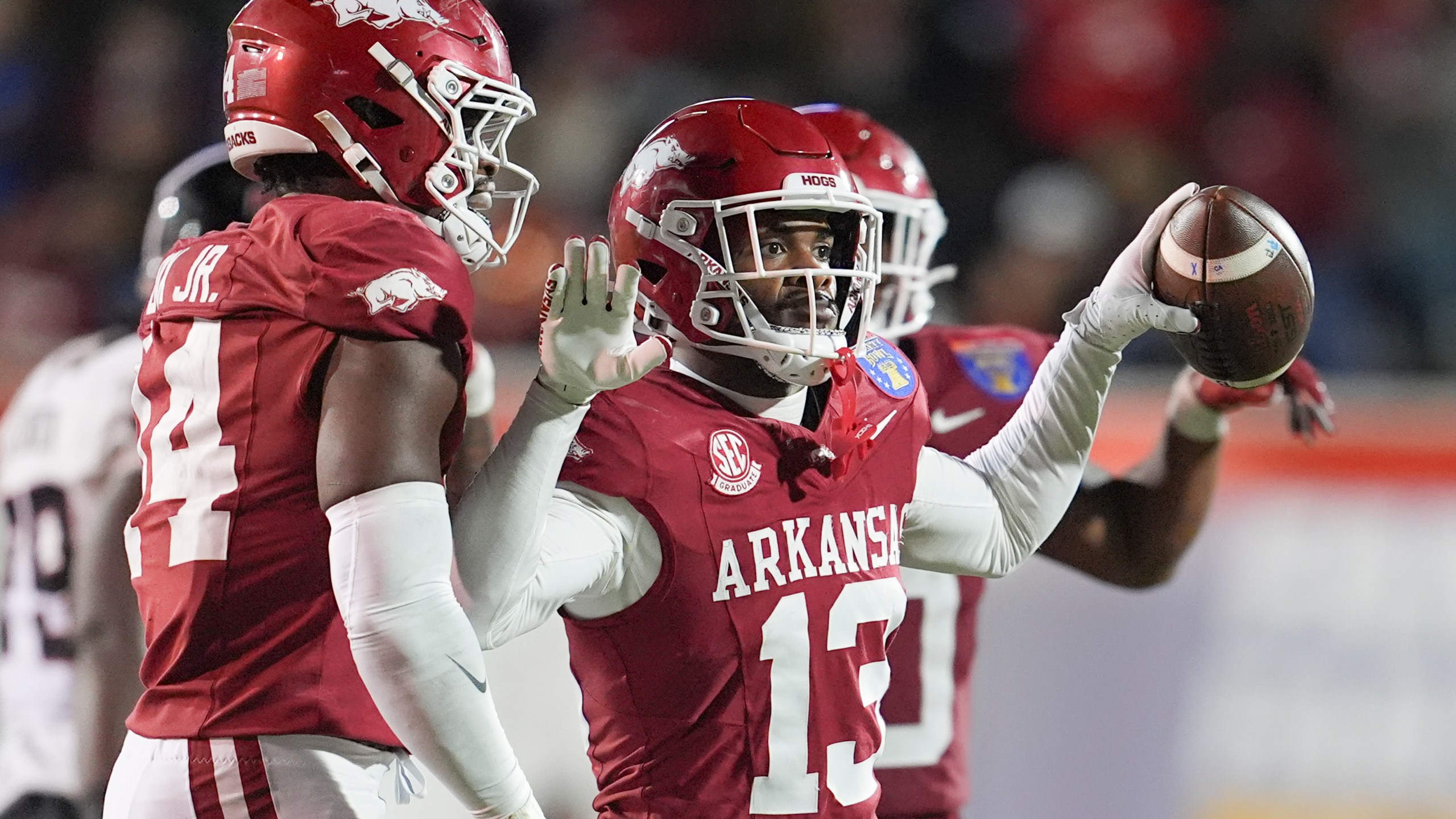 Arkansas defensive back Marquise Robinson (13) celebrates his interception during the second half of the Liberty Bowl NCAA college football game against Texas Tech, Friday, Dec. 27, 2024, in Memphis, Tenn. (AP Photo/George Walker IV)