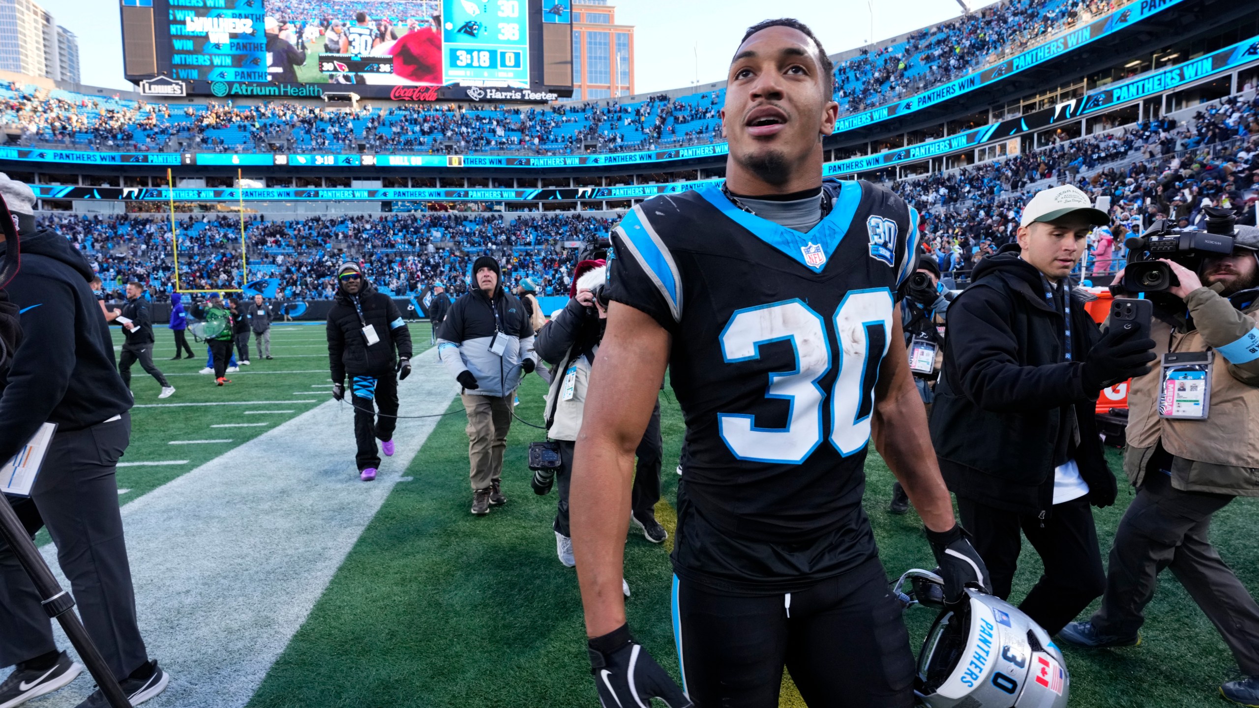 Carolina Panthers running back Chuba Hubbard leaves the field after scoring the winning touchdown against the Arizona Cardinals during overtime of an NFL football game, Sunday, Dec. 22, 2024, in Charlotte, N.C. (AP Photo/Rusty Jones)