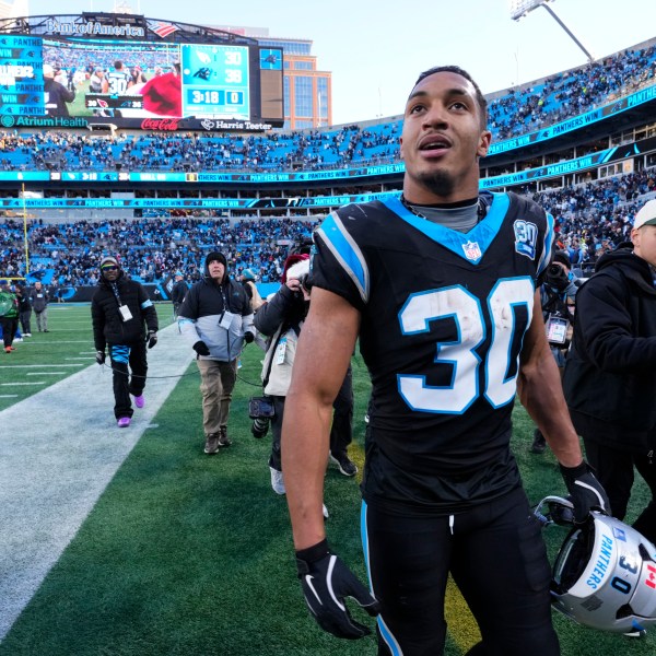 Carolina Panthers running back Chuba Hubbard leaves the field after scoring the winning touchdown against the Arizona Cardinals during overtime of an NFL football game, Sunday, Dec. 22, 2024, in Charlotte, N.C. (AP Photo/Rusty Jones)