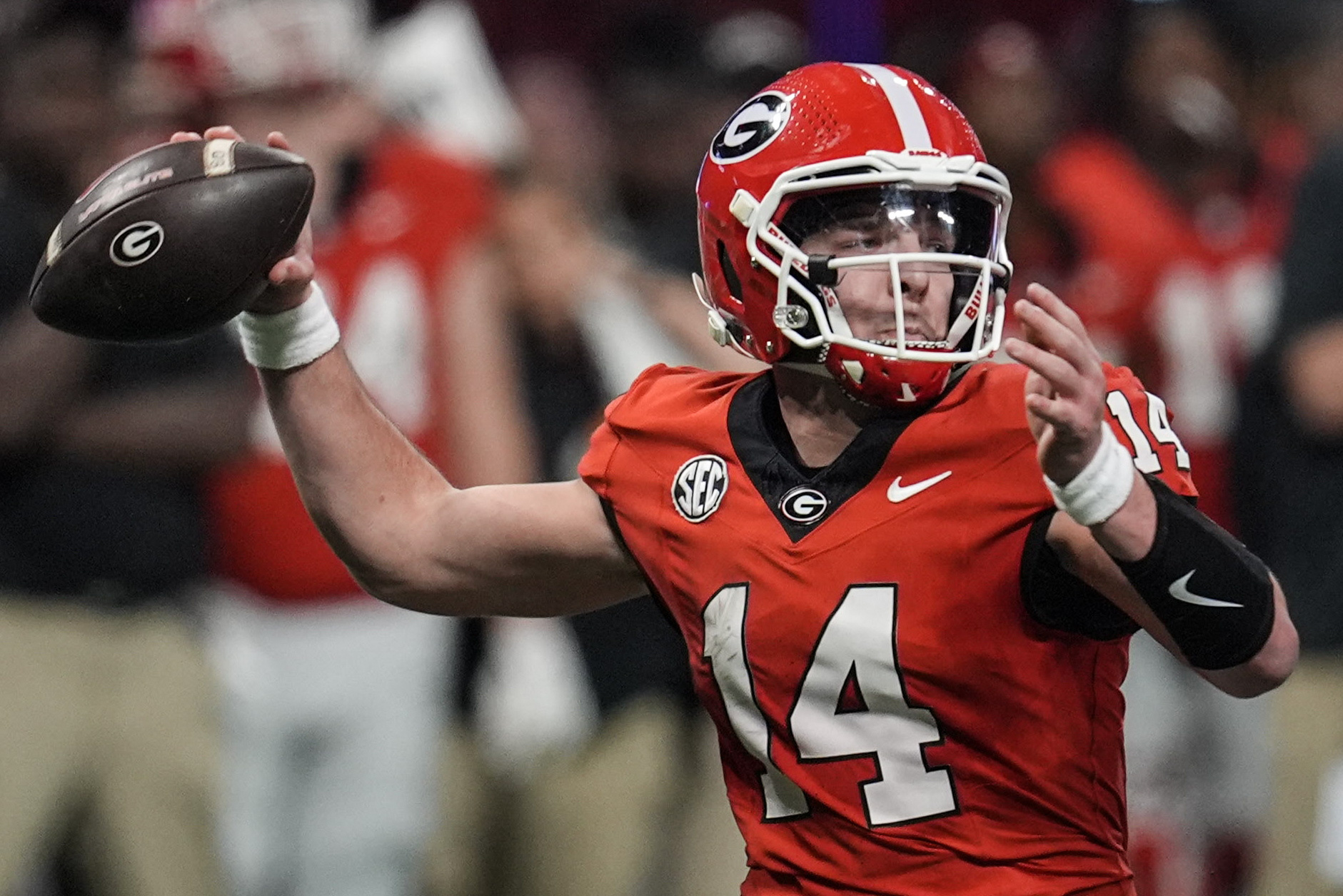 Georgia quarterback Gunner Stockton (14) passes in the pocket against Texas during the second half of the Southeastern Conference championship NCAA college football game, Saturday, Dec. 7, 2024, in Atlanta. (AP Photo/Mike Stewart)