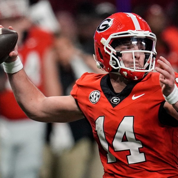 Georgia quarterback Gunner Stockton (14) passes in the pocket against Texas during the second half of the Southeastern Conference championship NCAA college football game, Saturday, Dec. 7, 2024, in Atlanta. (AP Photo/Mike Stewart)