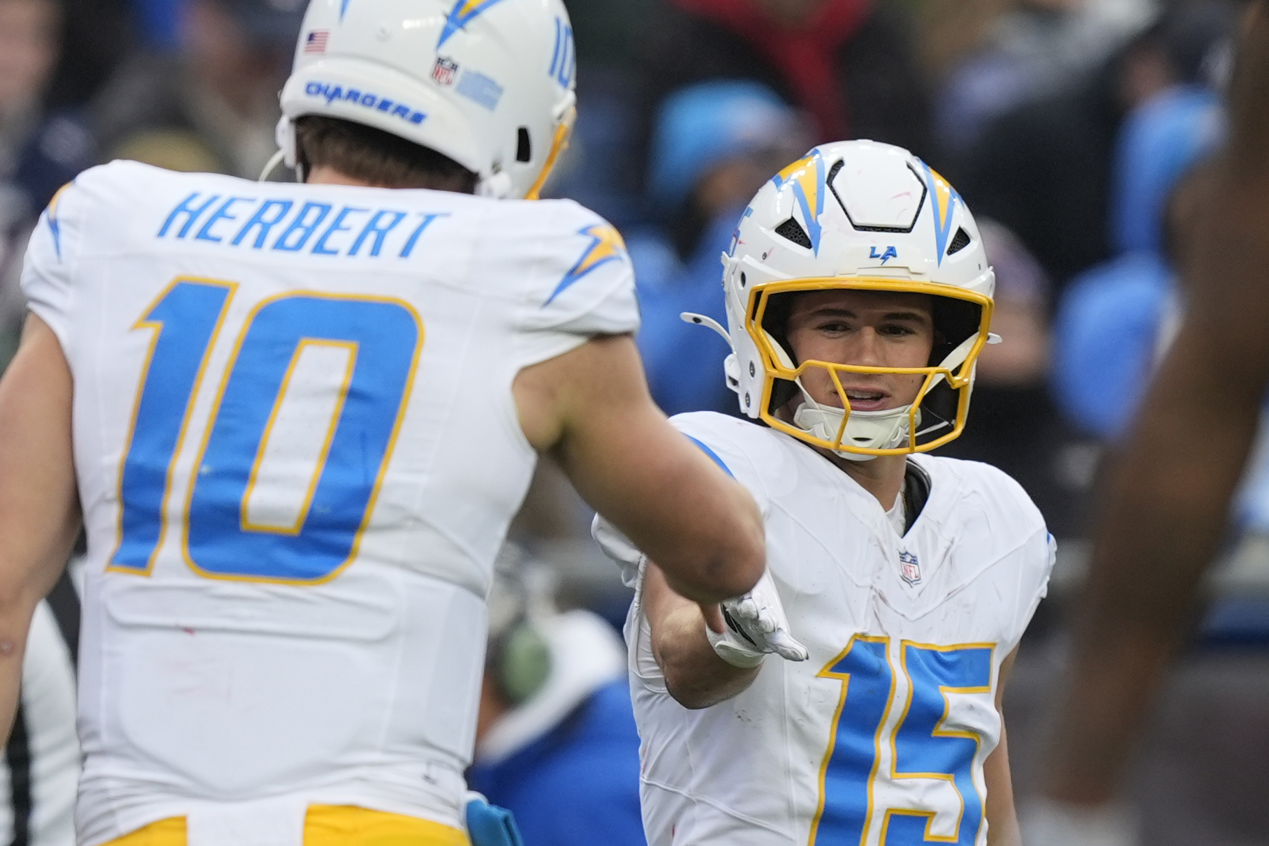 Los Angeles Chargers wide receiver Ladd McConkey (15) is congratulated by quarterback Justin Herbert (10) after his touchdown against the New England Patriots during the first half of an NFL football game, Saturday, Dec. 28, 2024, in Foxborough, Mass. (AP Photo/Michael Dwyer)