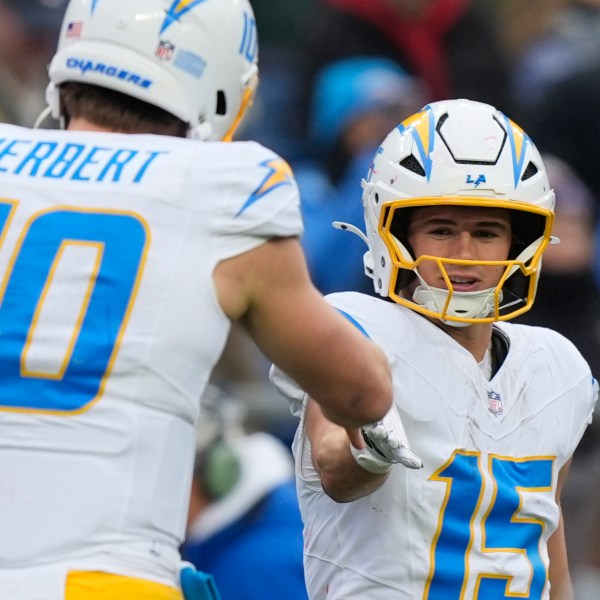 Los Angeles Chargers wide receiver Ladd McConkey (15) is congratulated by quarterback Justin Herbert (10) after his touchdown against the New England Patriots during the first half of an NFL football game, Saturday, Dec. 28, 2024, in Foxborough, Mass. (AP Photo/Michael Dwyer)