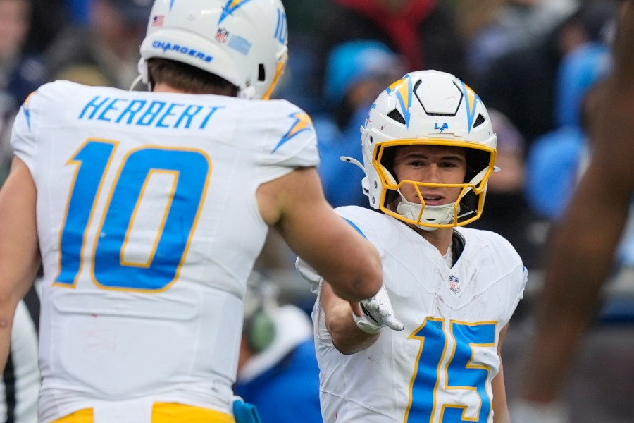 Los Angeles Chargers wide receiver Ladd McConkey (15) is congratulated by quarterback Justin Herbert (10) after his touchdown against the New England Patriots during the first half of an NFL football game, Saturday, Dec. 28, 2024, in Foxborough, Mass. (AP Photo/Michael Dwyer)