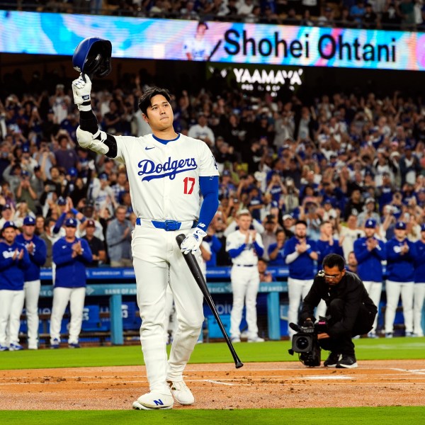 FILE - Los Angeles Dodgers designated hitter Shohei Ohtani (17) is honored for being first MLB player to achieve 50 home runs and 50 stolen bases in a single season during the first inning of a baseball game against the Colorado Rockies in Los Angeles, Friday, Sept. 20, 2024. (AP Photo/Ashley Landis, File)