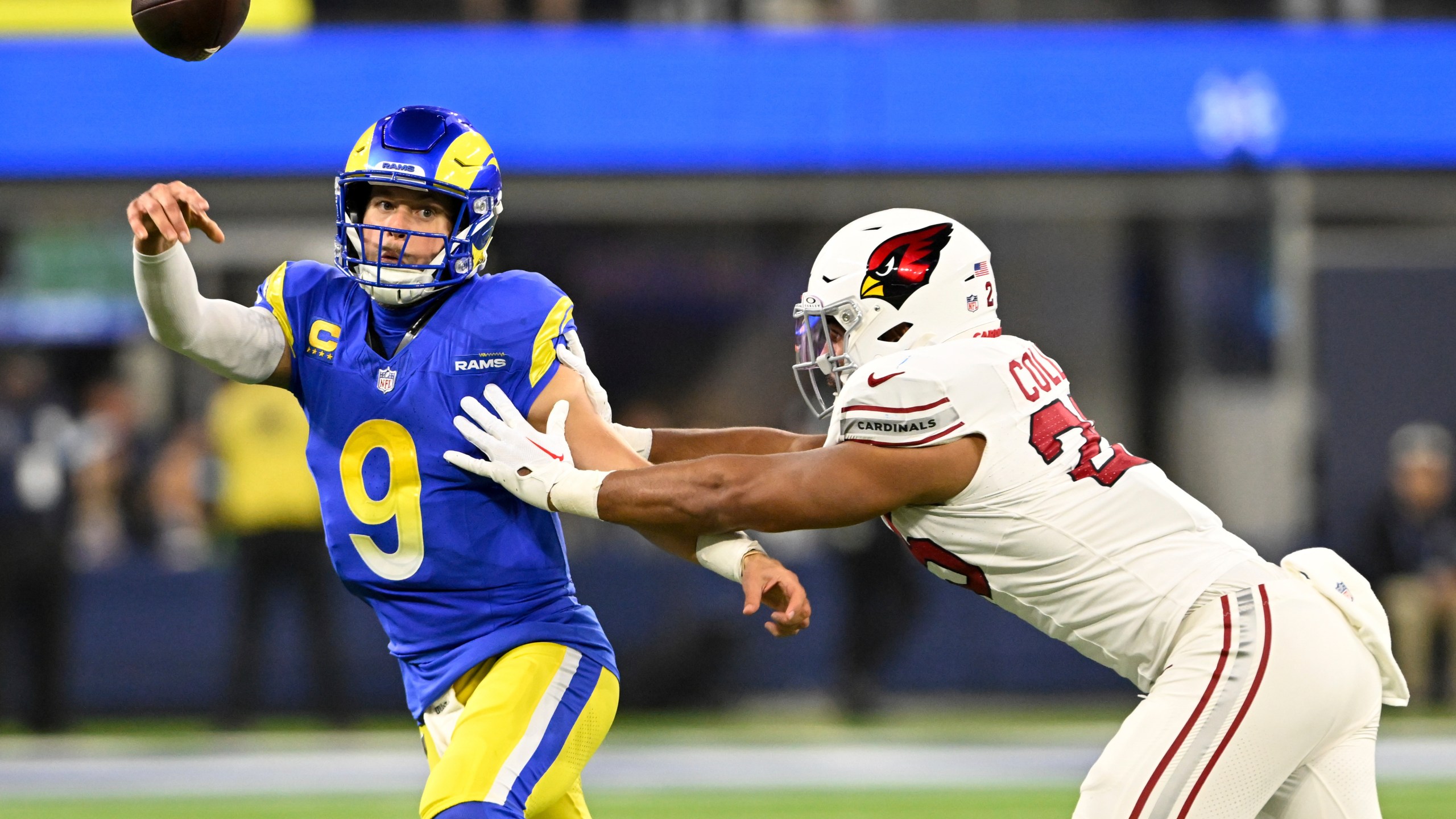 Los Angeles Rams quarterback Matthew Stafford (9) throws under pressure from Arizona Cardinals linebacker Zaven Collins (25) during the first half of an NFL football game Saturday, Dec. 28, 2024, in Inglewood, Calif. (AP Photo/Alex Gallardo)