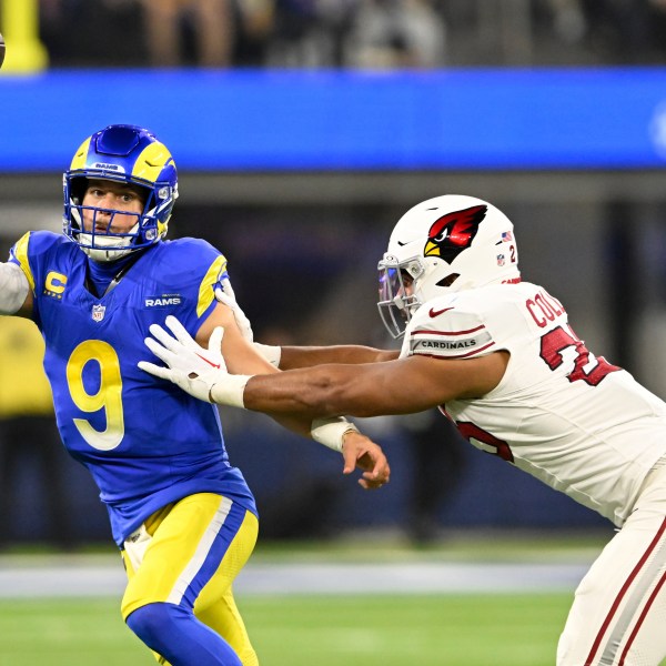 Los Angeles Rams quarterback Matthew Stafford (9) throws under pressure from Arizona Cardinals linebacker Zaven Collins (25) during the first half of an NFL football game Saturday, Dec. 28, 2024, in Inglewood, Calif. (AP Photo/Alex Gallardo)