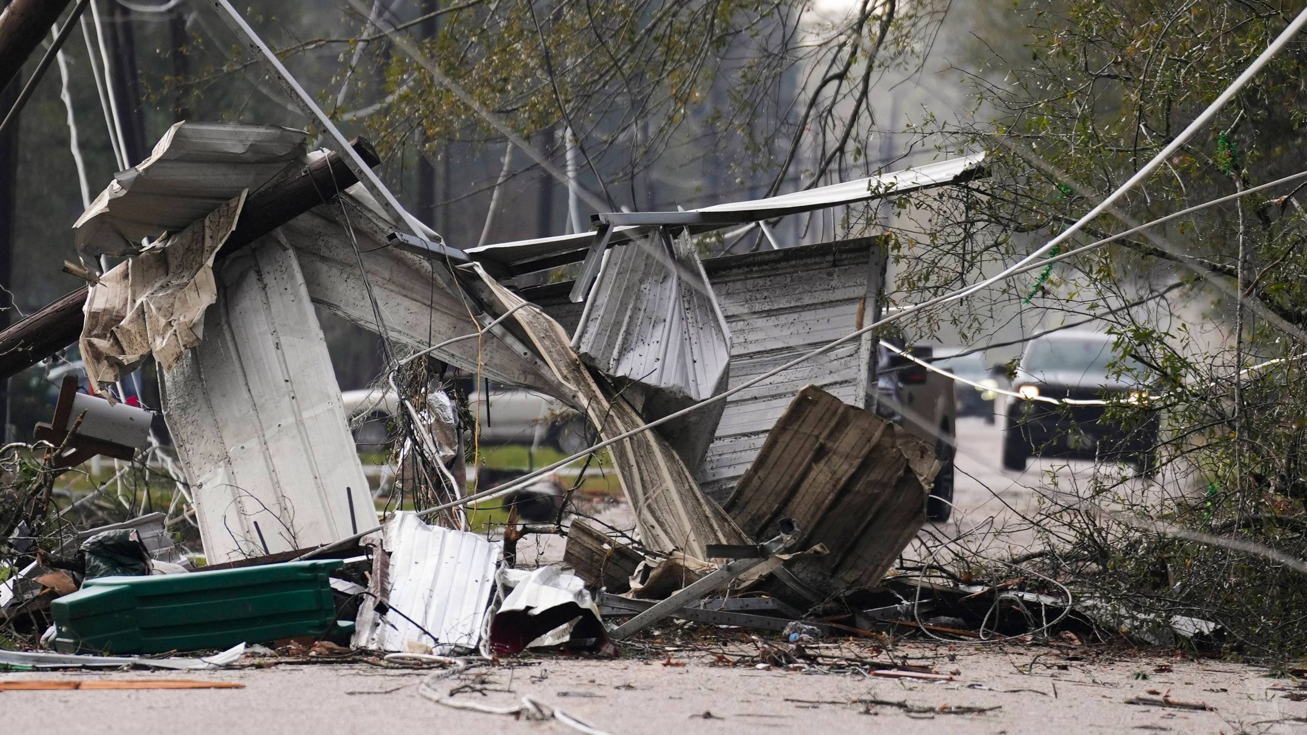 Debris block a portion of Porter Lane after strong thunderstorms pass through the Greater Houston region, Saturday, Dec. 28, 2024, in Porter Heights. (Jason Fochtman/Houston Chronicle via AP)