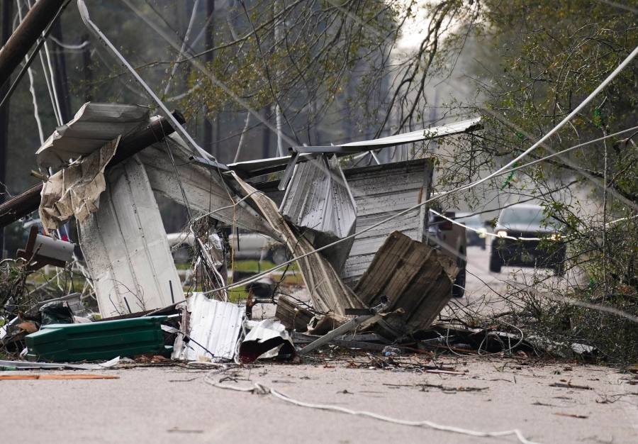 Debris block a portion of Porter Lane after strong thunderstorms pass through the Greater Houston region, Saturday, Dec. 28, 2024, in Porter Heights. (Jason Fochtman/Houston Chronicle via AP)