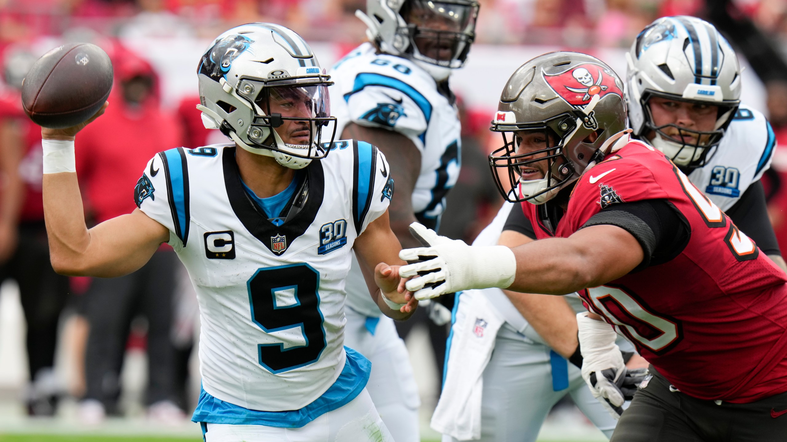 Carolina Panthers quarterback Bryce Young passes under pressure from Tampa Bay Buccaneers defensive end Logan Hall during the first half of an NFL football game Sunday, Dec. 29, 2024, in Tampa, Fla. (AP Photo/Chris O'Meara)