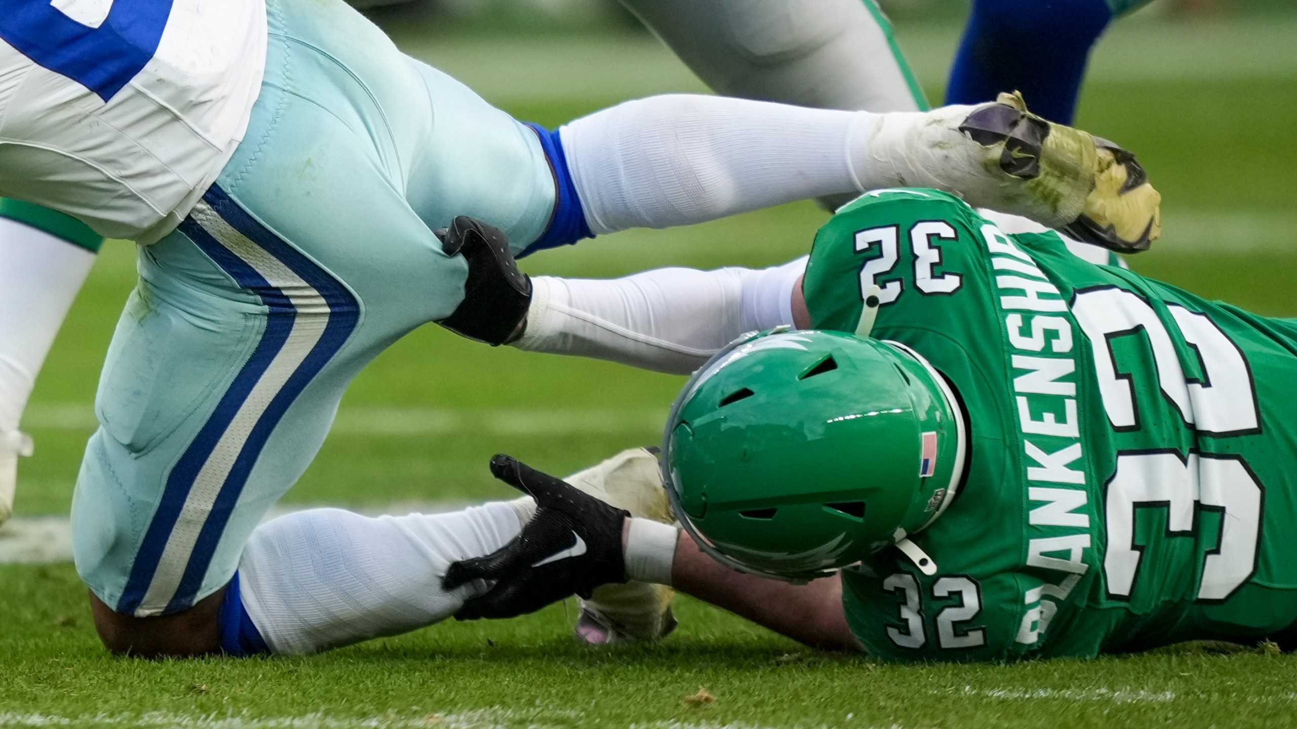 Philadelphia Eagles safety Reed Blankenship, right, grabs at Dallas Cowboys running back Rico Dowdle while tackling him during the second half of an NFL football game, Sunday, Dec. 29, 2024, in Philadelphia. (AP Photo/Matt Slocum)