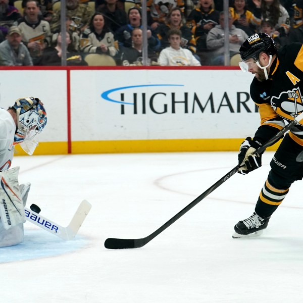 New York Islanders goaltender Marcus Hogberg (50) makes a save against Pittsburgh Penguins' Bryan Rust (17) during the second period of an NHL hockey game Sunday, Dec. 29, 2024, in Pittsburgh. (AP Photo/Matt Freed)