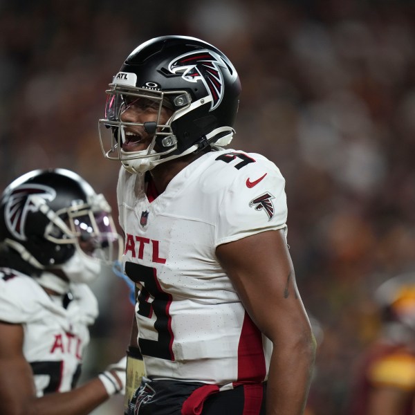 Atlanta Falcons quarterback Michael Penix Jr. (9) celebrates a touchdown during the second half of an NFL football game against the Washington Commanders, Sunday, Dec. 29, 2024, in Landover, Md. (AP Photo/Stephanie Scarbrough)