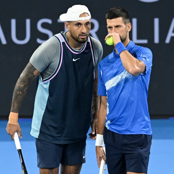 Australia's Nick Kyrgios, left, talks with Serbia's Novak Djokovic during their doubles match against Alexander Erler of Austria and Andreas Mies of Germany in the Brisbane International, at the Queensland Tennis Centre in Brisbane, Australia, Monday, Dec. 30, 2024. (Darren England/AAP Image via AP)