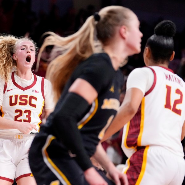 Southern California guard Avery Howell, left, celebrates after scoring with guard JuJu Watkins, right, as Michigan guard Olivia Olson walks away during the second half of an NCAA college basketball game, Sunday, Dec. 29, 2024, in Los Angeles. (AP Photo/Mark J. Terrill)