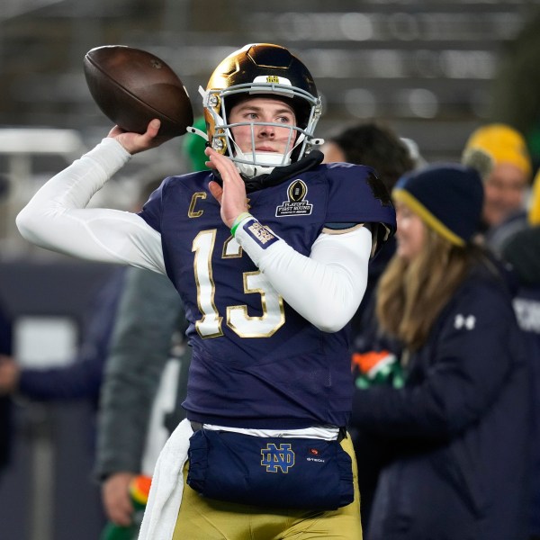 Notre Dame quarterback Riley Leonard (13) throws before the first half in the first round of the College Football Playoff against Indiana, Friday, Dec. 20, 2024, in South Bend, Ind. (AP Photo/Darron Cummings)