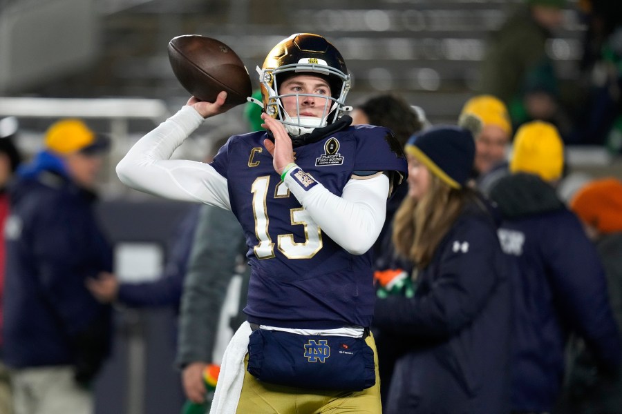 Notre Dame quarterback Riley Leonard (13) throws before the first half in the first round of the College Football Playoff against Indiana, Friday, Dec. 20, 2024, in South Bend, Ind. (AP Photo/Darron Cummings)