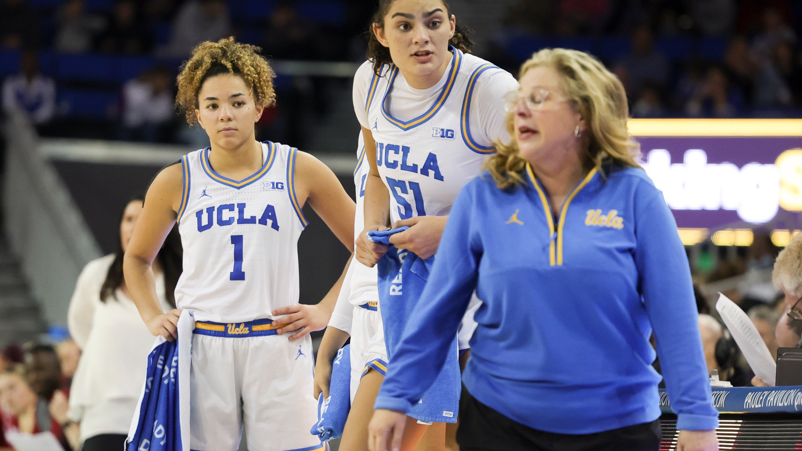 UCLA guard Kiki Rice, left, and center Lauren Betts, center, speak with head coach Cori Close during the second half of an NCAA college basketball game against Nebraska Sunday, Dec. 29, 2024, in Los Angeles. (AP Photo/Ryan Sun)