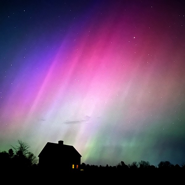 FILE - The northern lights flare in the sky over a farmhouse, May 10, 2024, in Brunswick, Maine. (AP Photo/Robert F. Bukaty, File)