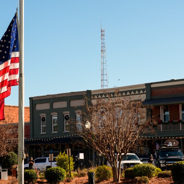 A flag flies at half-staff on main street in the aftermath of former President Jimmy Carter's death, Monday, Dec. 30, 2024, in Plains, Ga. Carter died Sunday at the age of 100.(AP Photo/Mike Stewart)