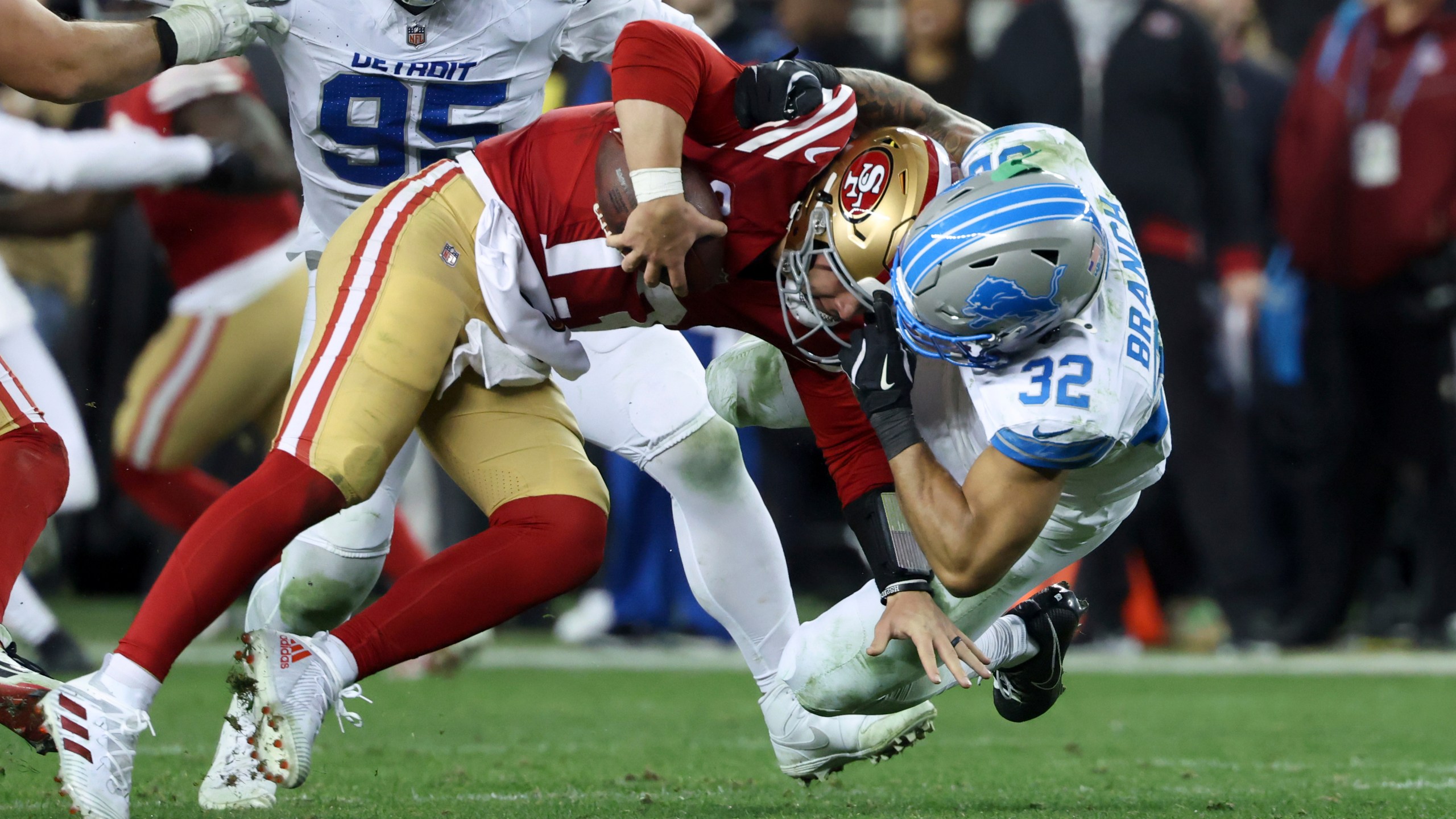 San Francisco 49ers quarterback Brock Purdy (13) is tackled by Detroit Lions safety Brian Branch (32) during the second half of an NFL football game Monday, Dec. 30, 2024, in Santa Clara, Calif. (AP Photo/Jed Jacobsohn)