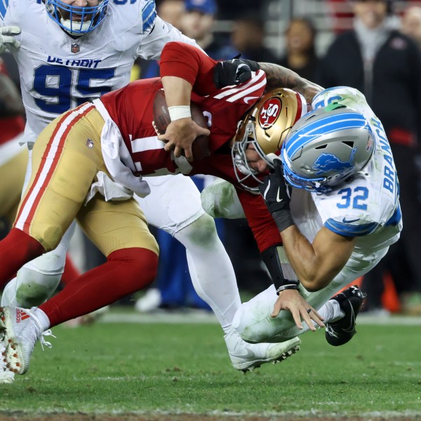 San Francisco 49ers quarterback Brock Purdy (13) is tackled by Detroit Lions safety Brian Branch (32) during the second half of an NFL football game Monday, Dec. 30, 2024, in Santa Clara, Calif. (AP Photo/Jed Jacobsohn)