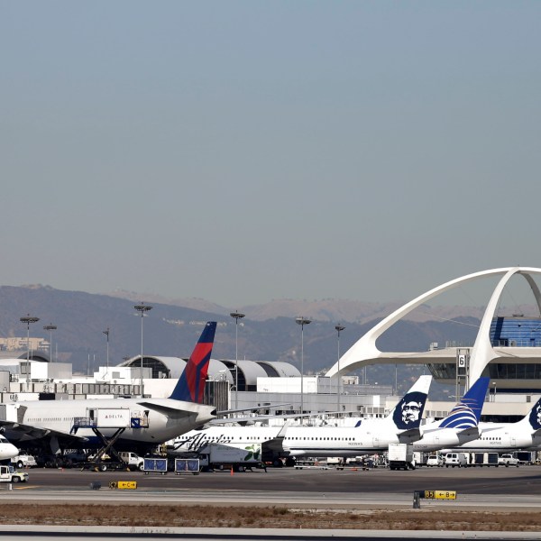 FILE - Airplanes sit on the tarmac at Los Angeles International Airport Friday, Nov. 1, 2013. (AP Photo/Gregory Bull, File)