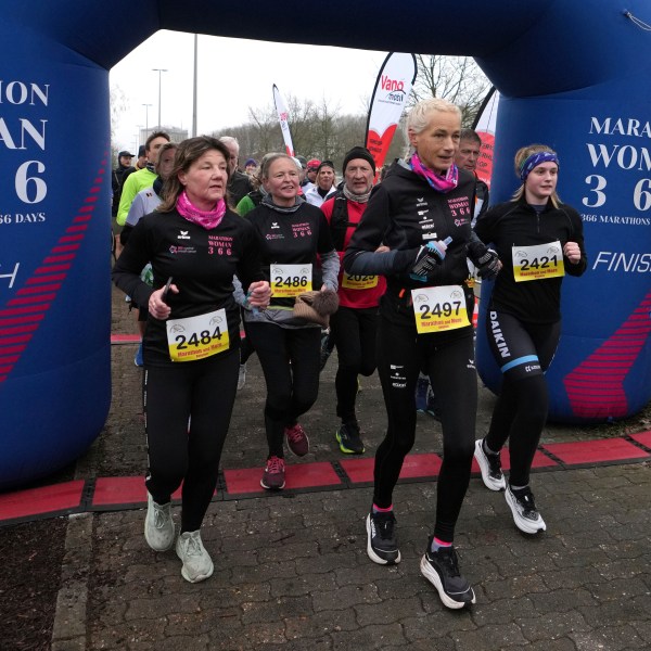 Belgian ultra runner Hilde Dosogne, center, runs during her 366th consecutive marathon in Ghent, Belgium, Tuesday, Dec. 31, 2024. (AP Photo/Virginia Mayo)