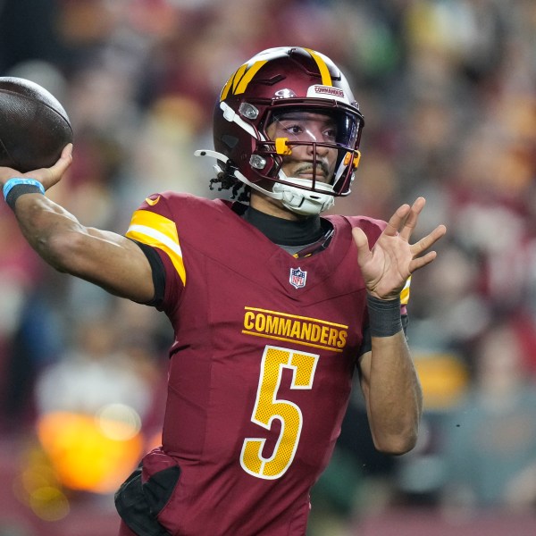 Washington Commanders quarterback Jayden Daniels (5) passes during the first half of an NFL football game against the Atlanta Falcons, Sunday, Dec. 29, 2024, in Landover. (AP Photo/Stephanie Scarbrough)