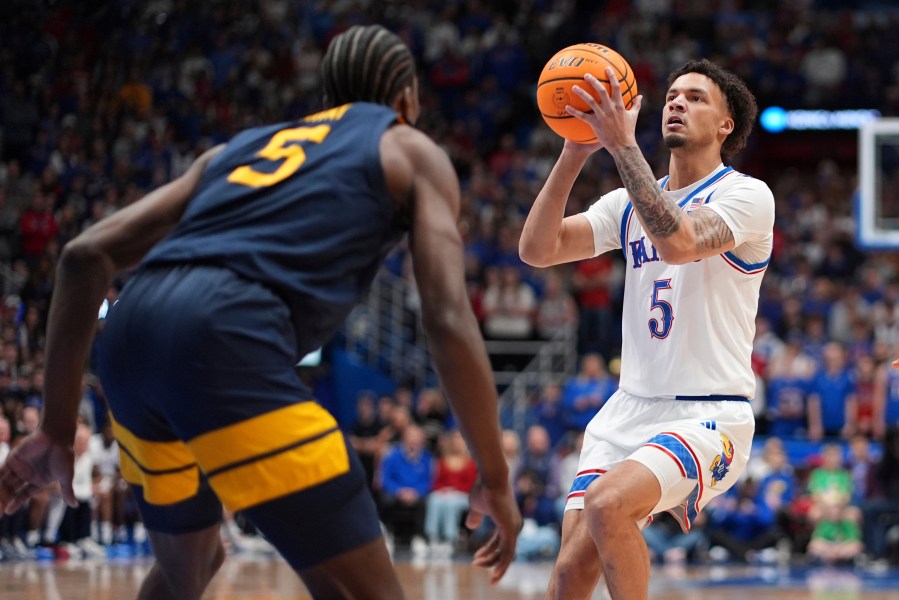 Kansas guard Zeke Mayo (5) looks to shoot during the first half of an NCAA college basketball game against West Virginia, Tuesday, Dec. 31, 2024, in Lawrence, Kan. (AP Photo/Charlie Riedel)